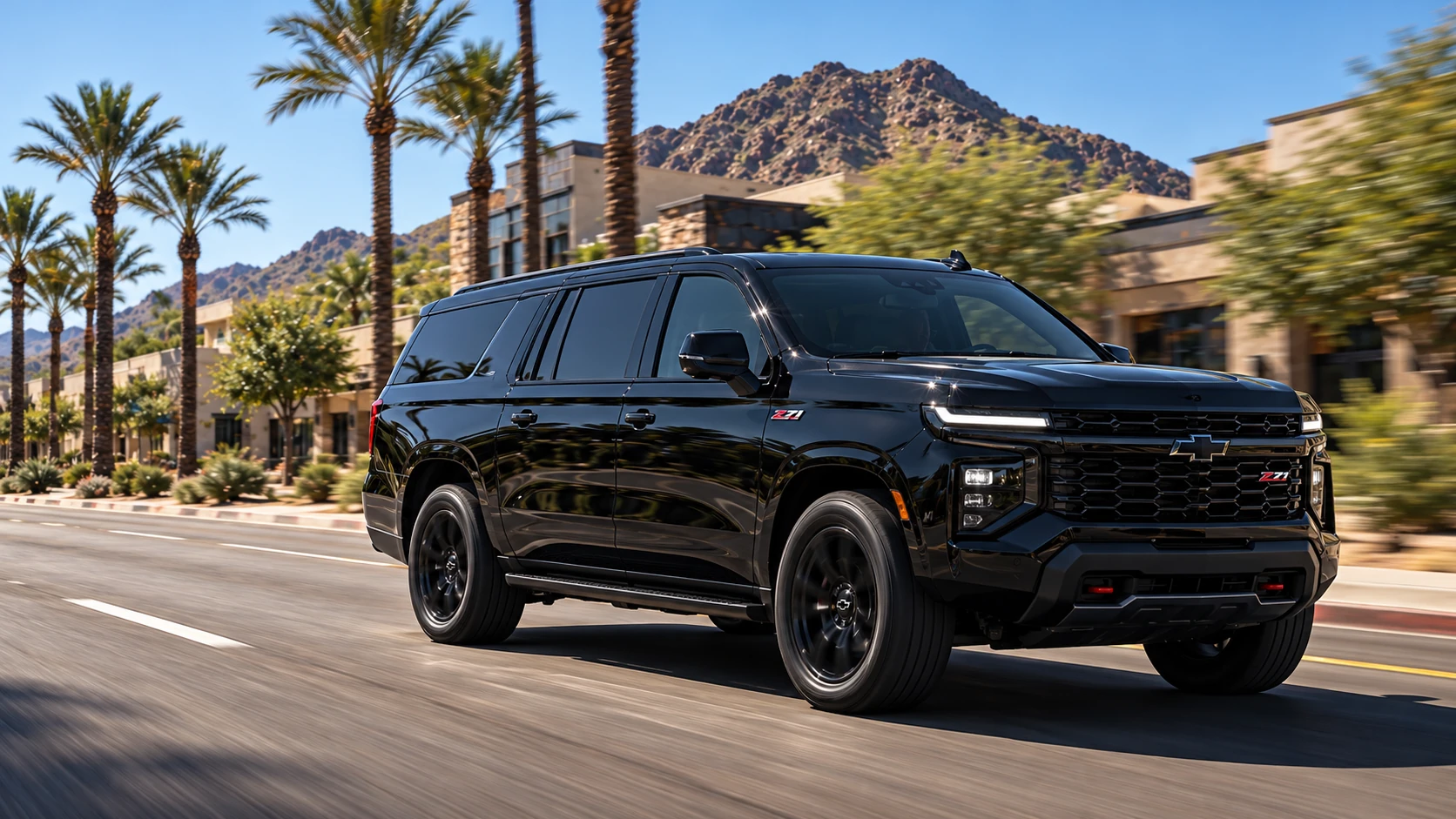 Black Chevrolet Suburban Z71 driving through Scottsdale with palms and mountains behind it